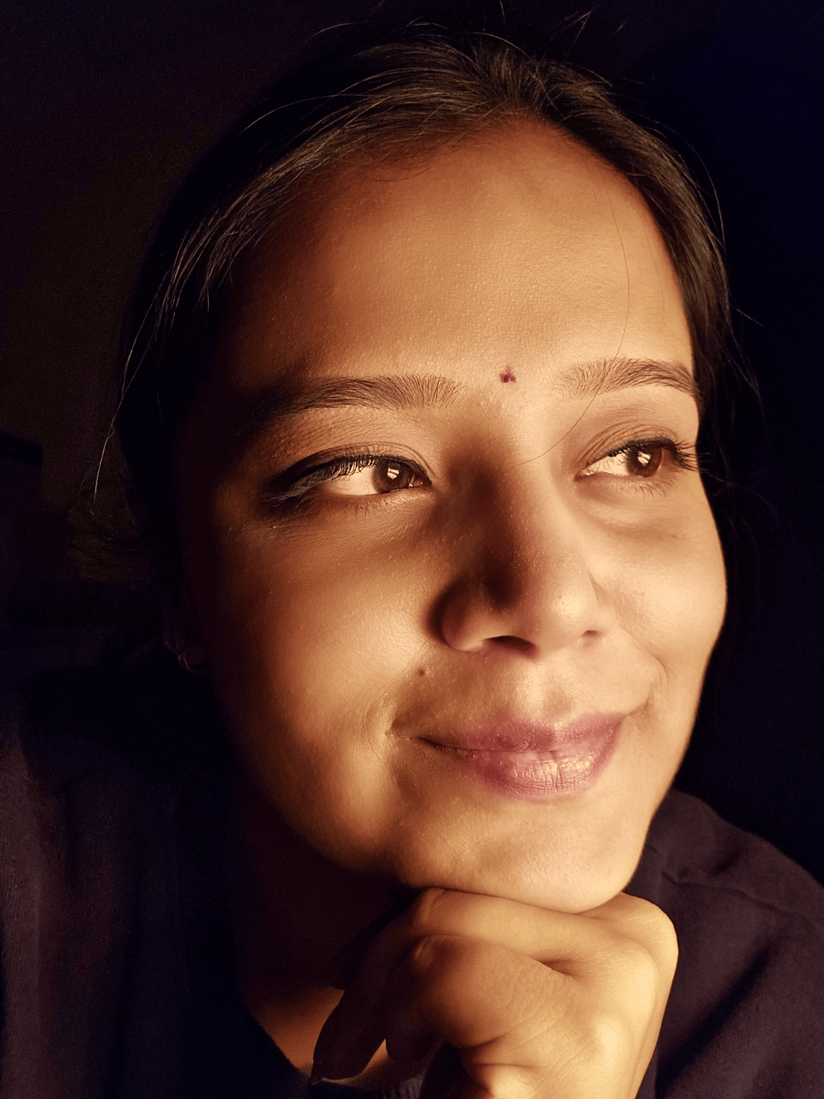 Indian classical music teacher Vaishnavi Gupta in traditional attire holding tanpura in music studio